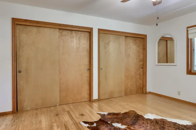 a view of a porch with furniture and wooden floor