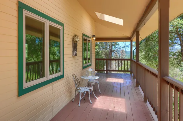 a view of a roof deck with wooden floor and fence