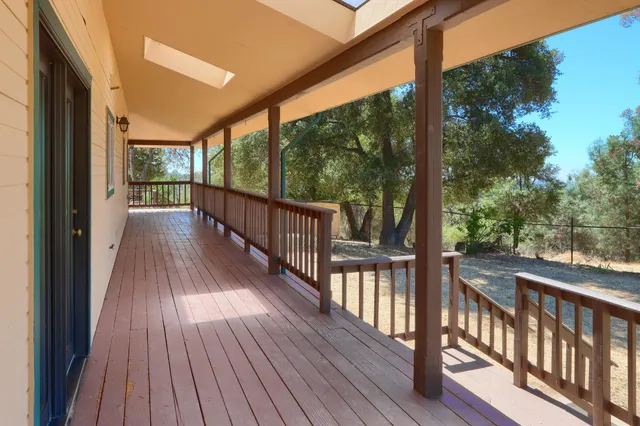 a view of a house with a wooden deck
