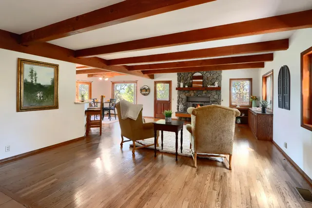 a dining room with furniture and wooden floor