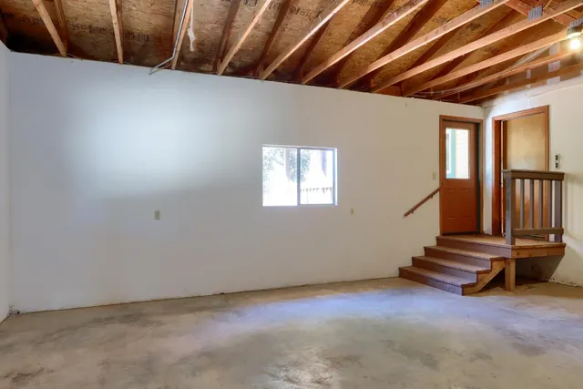 a sign that is sitting in front of a tree