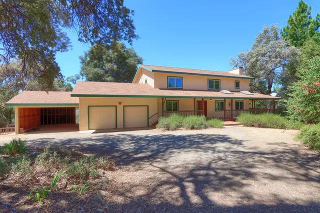 an aerial view of residential house with yard and green space