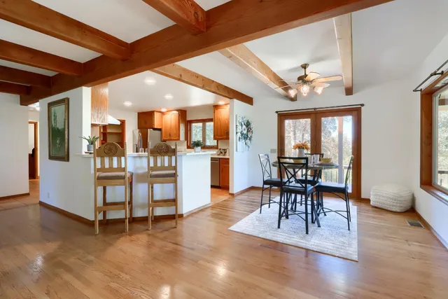 a view of a dining room with furniture window and wooden floor