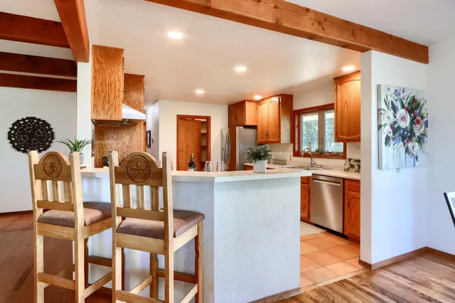 a kitchen with stainless steel appliances granite countertop a stove a sink and a refrigerator