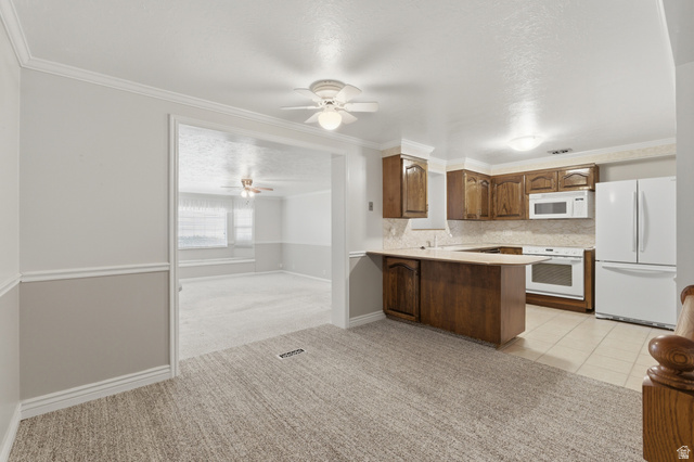 148 Tennyson Avenue Sandy, UT 84070 - Photo 13 of 55 Kitchen featuring wood cabinetry and white appliances, with light-toned tile flooring
