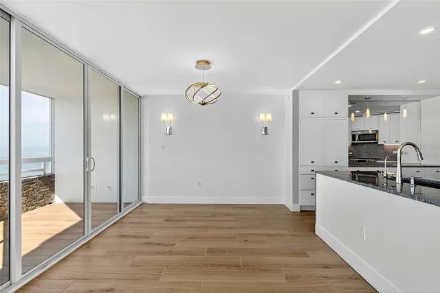 a kitchen with stainless steel appliances a stove microwave and refrigerator