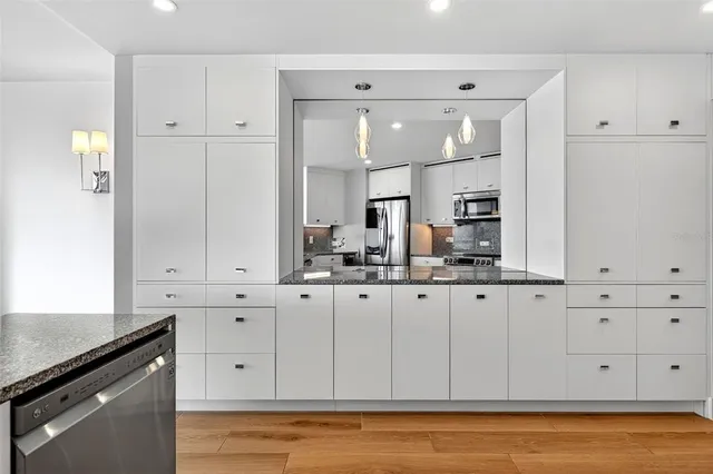 a large bedroom with a bed and a flat screen tv