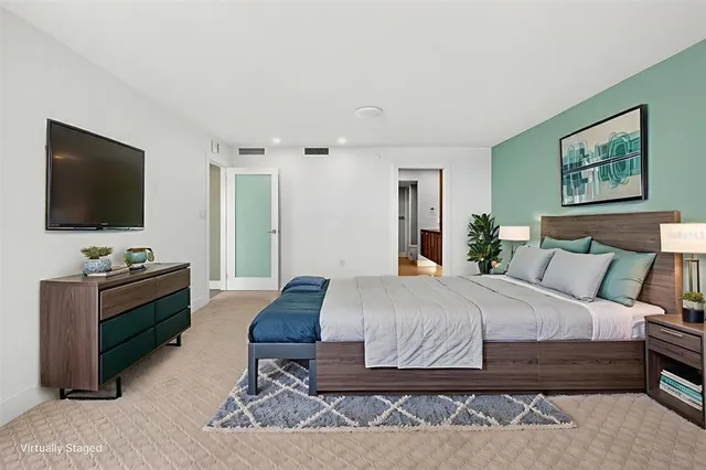 a living room with fireplace furniture and a large window