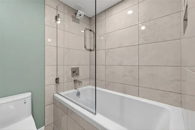 an aerial view of a house with a yard and lake view