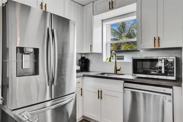 a living room with furniture kitchen view and a window