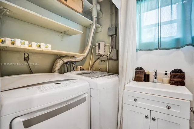 a front view of a house with a yard and potted plants