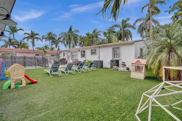 a patio with a table and chairs under an umbrella