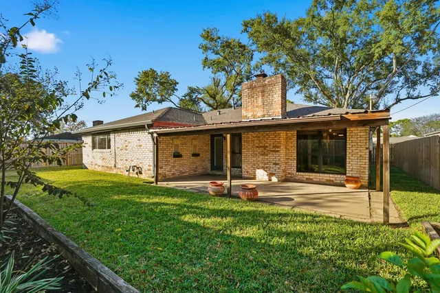 a front view of a house with a garden and patio