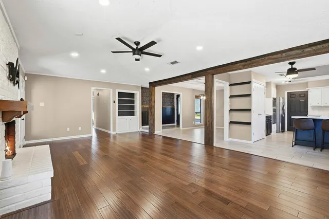 a view of a livingroom with a hardwood floor and staircase