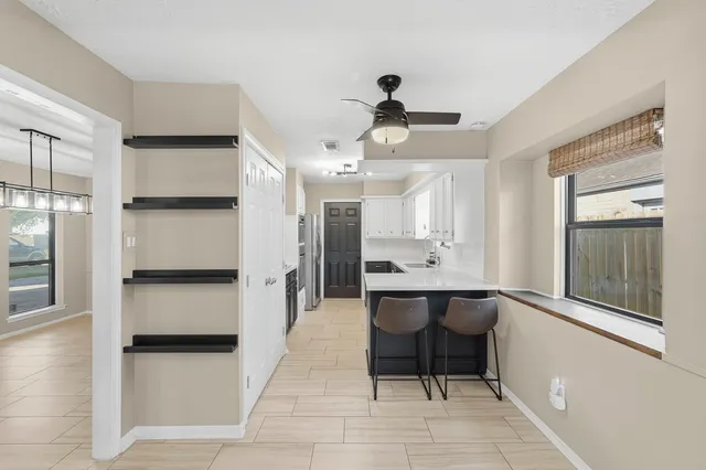 a spacious bathroom with a double vanity sink and a mirror