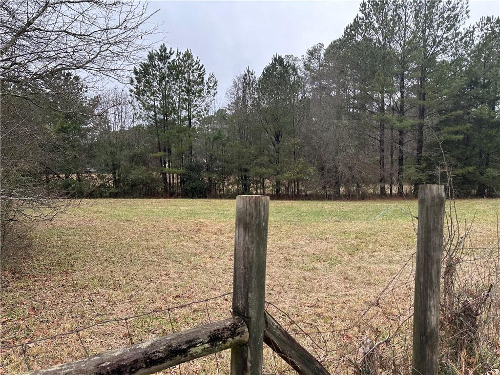 1975 Flat Shoals Road Southeast Conyers, GA 30013 - Photo 4 of 5 a view of a yard with wooden fence