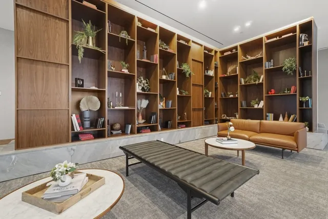 a living room with furniture and a large mirror