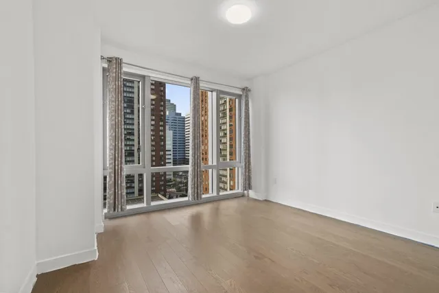 wooden floor and window in an empty room