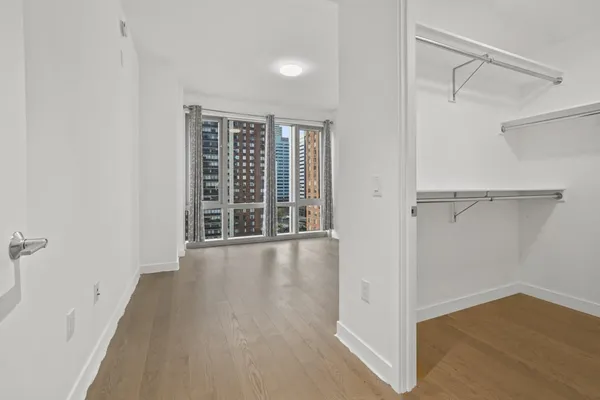 a living room with furniture a large window and a flat screen tv