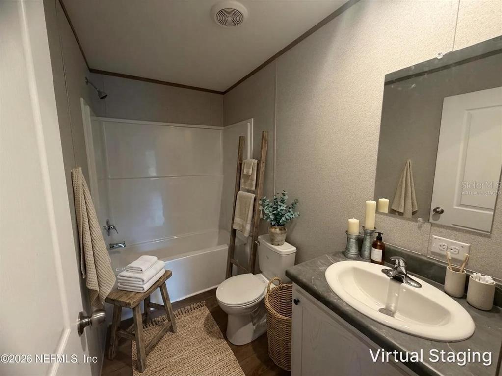 114 Nutmeg Trail Interlachen, FL 32148 - Photo 23 of 33 a bathroom with a sink toilet a mirror and shower