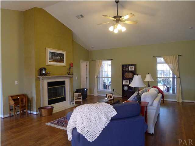 4890 Timber Ridge Drive Pace, FL 32571 - Photo 3 of 18 a living room with furniture and a fireplace