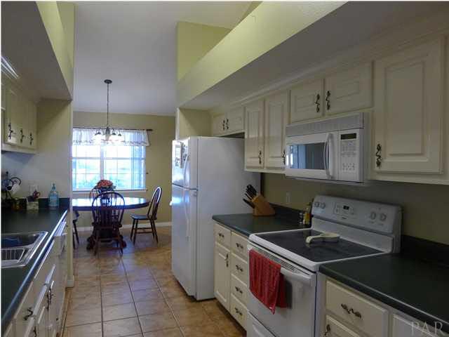 4890 Timber Ridge Drive Pace, FL 32571 - Photo 6 of 18 a kitchen with a stove and a refrigerator