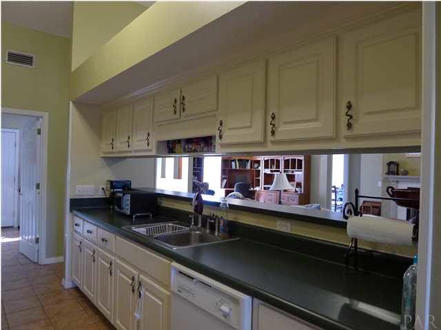 4890 Timber Ridge Drive Pace, FL 32571 - Photo 7 of 18 a kitchen that has a lot of cabinets in it