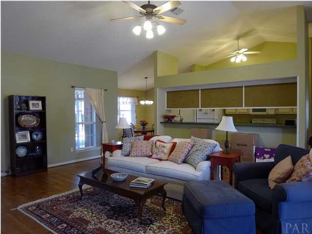 4890 Timber Ridge Drive Pace, FL 32571 - Photo 8 of 18 a living room with furniture and wooden floor
