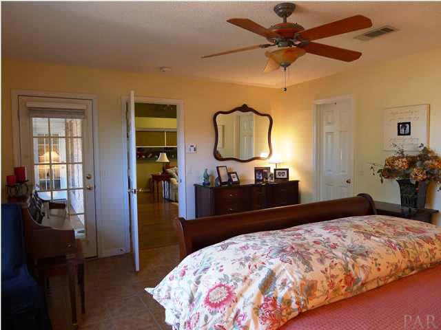 4890 Timber Ridge Drive Pace, FL 32571 - Photo 10 of 18 a bedroom with a bed and a dresser