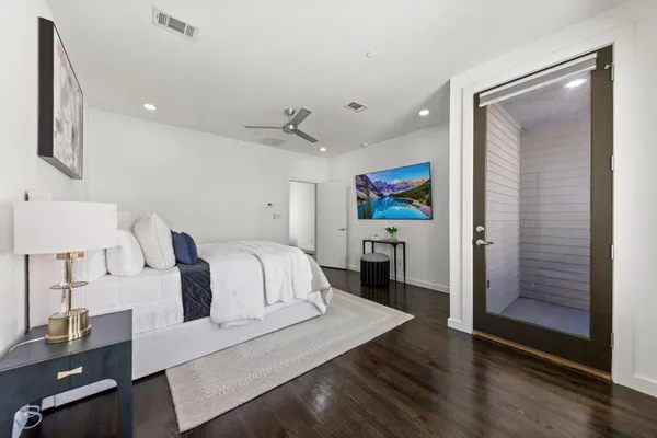 a spacious bedroom with a bed and a desk