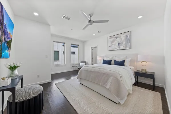 a spacious bedroom with a bed and furniture