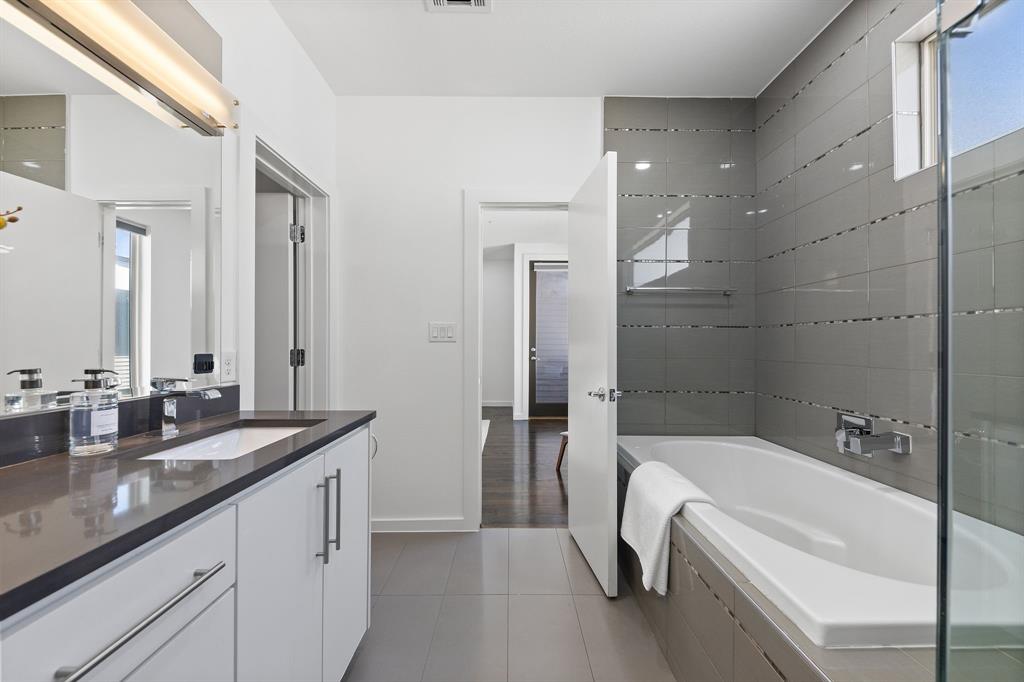1915 Summit Avenue, Unit 2 Dallas, TX 75206 - Photo 14 of 39 a bathroom with a granite countertop tub sink and mirror