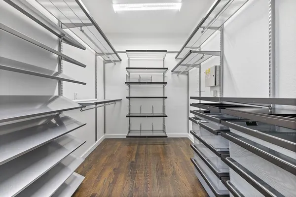 a kitchen with wooden floors and appliances