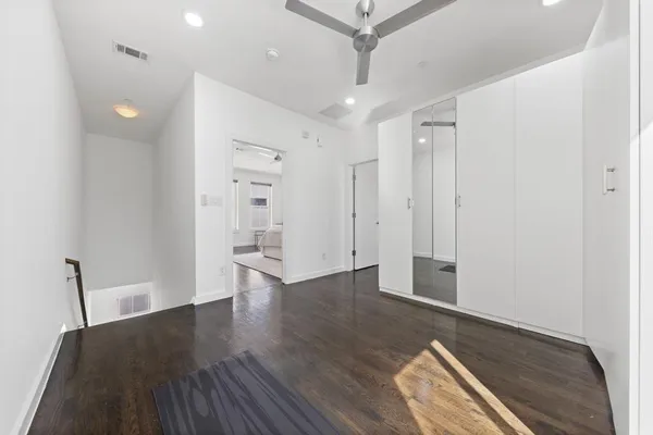 a view of a hallway with wooden floor