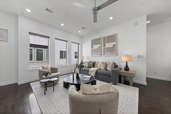 a living room with furniture and wooden floor