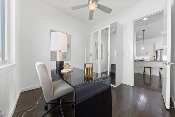 a dining room with furniture and wooden floor