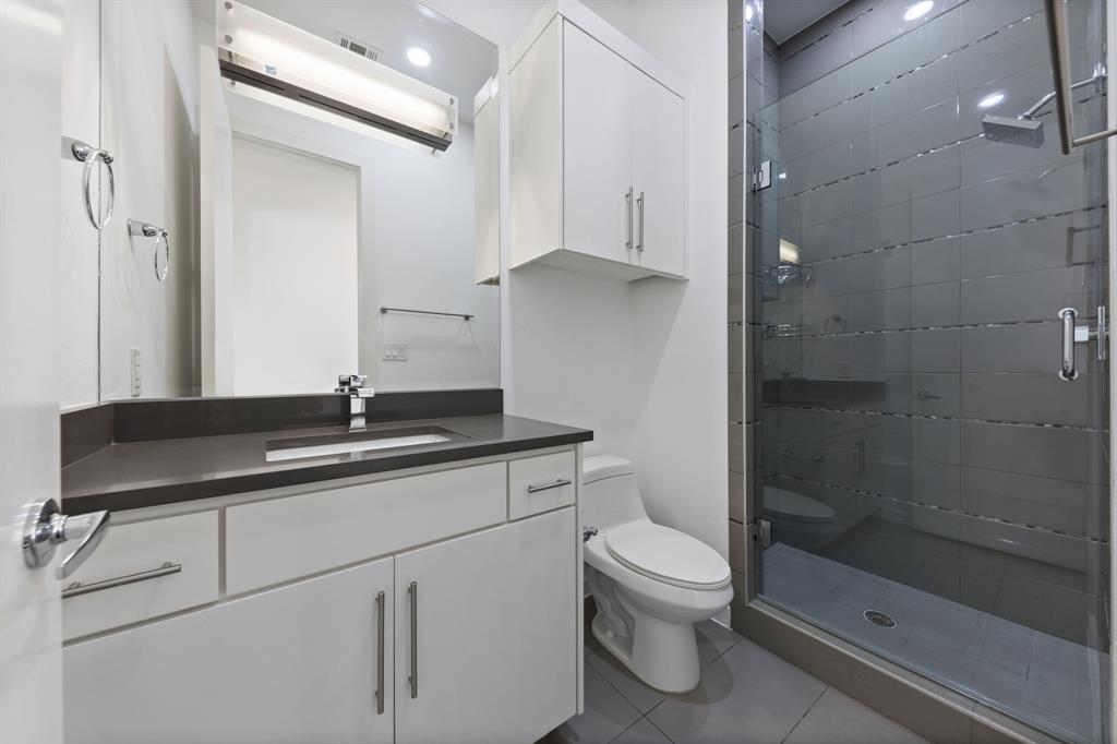 1915 Summit Avenue, Unit 2 Dallas, TX 75206 - Photo 25 of 39 a bathroom with a sink a toilet and shower