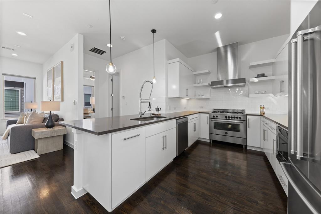 1915 Summit Avenue, Unit 2 Dallas, TX 75206 - Photo 5 of 39 a kitchen with stainless steel appliances a sink a stove and a wooden floors
