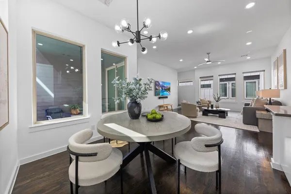 a view of a dining room with furniture wooden floor and chandelier