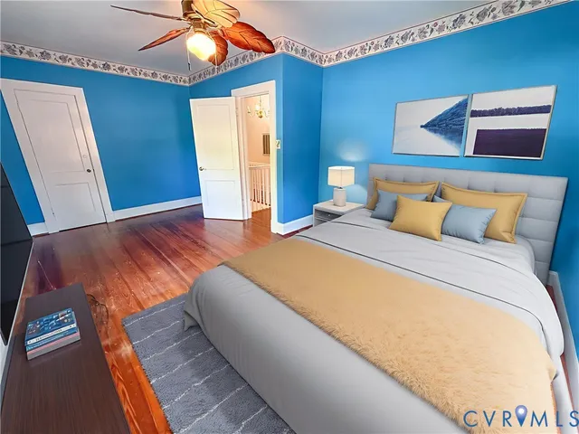 a bedroom with a bed and a painting on the wall