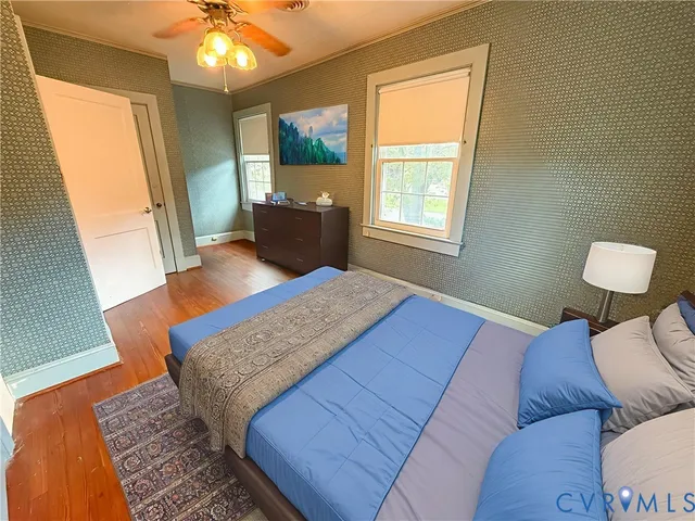 a bedroom with a bed and wooden floor