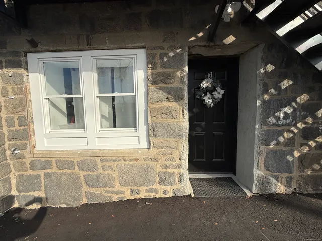 a front view of building with car parked