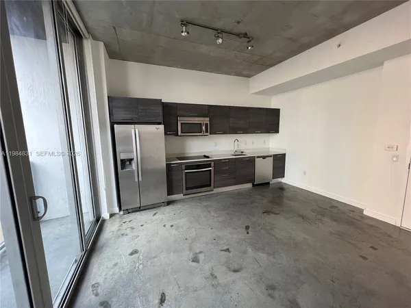 a kitchen with stainless steel appliances a refrigerator and a sink