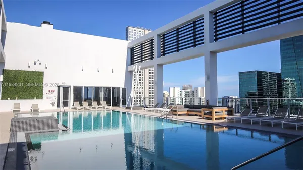 a view of swimming pool with outdoor seating and plants