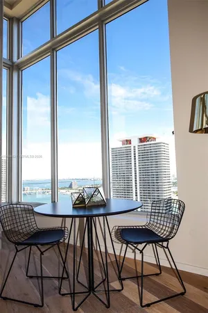a view of a chairs and table in the balcony