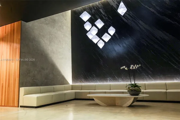 a living room with furniture and a lamp