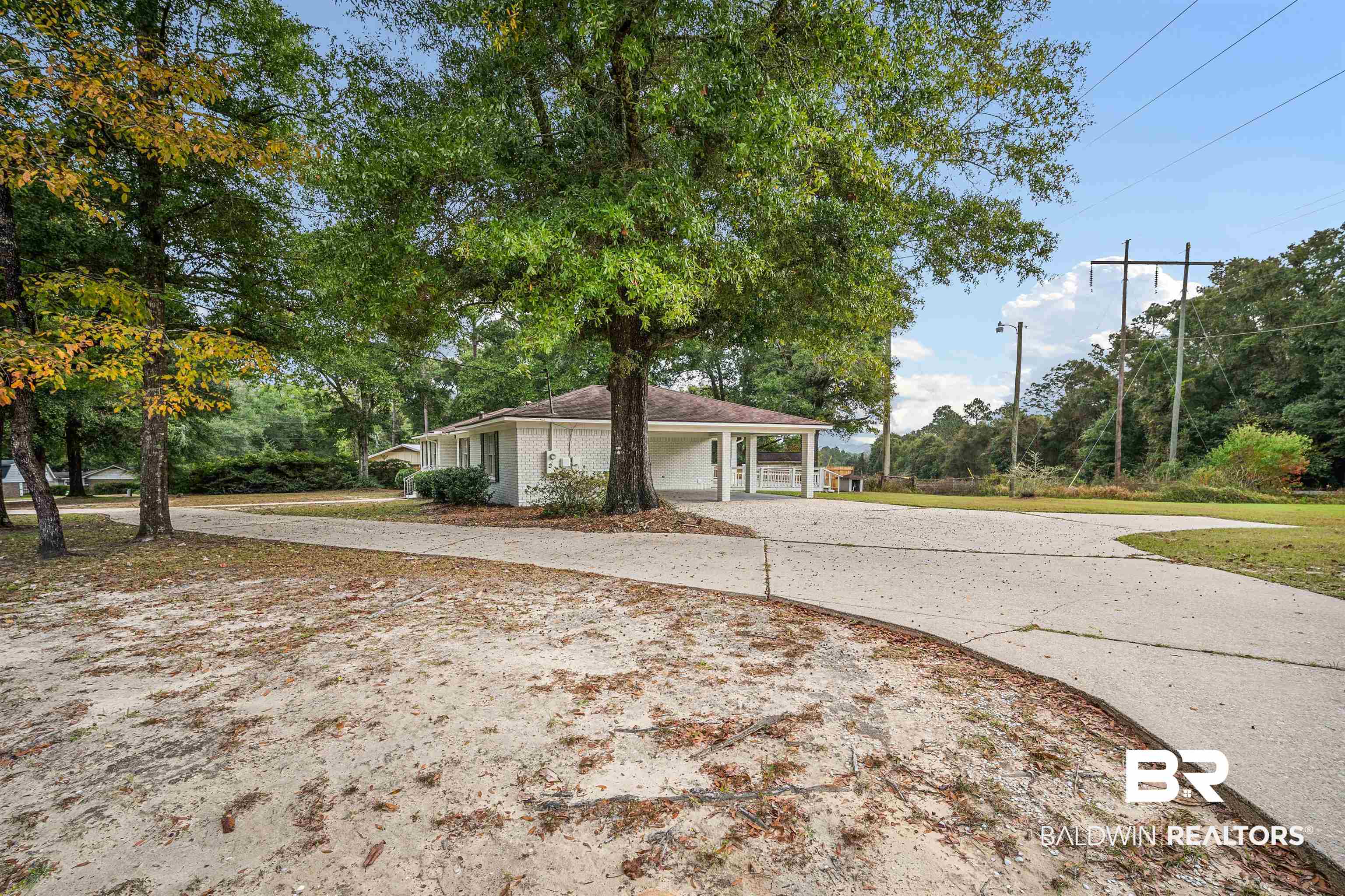 3050 Lacoste Road Mobile, AL 36618 - Photo 3 of 30 View of front of house with concrete driveway, a carport, and covered porch