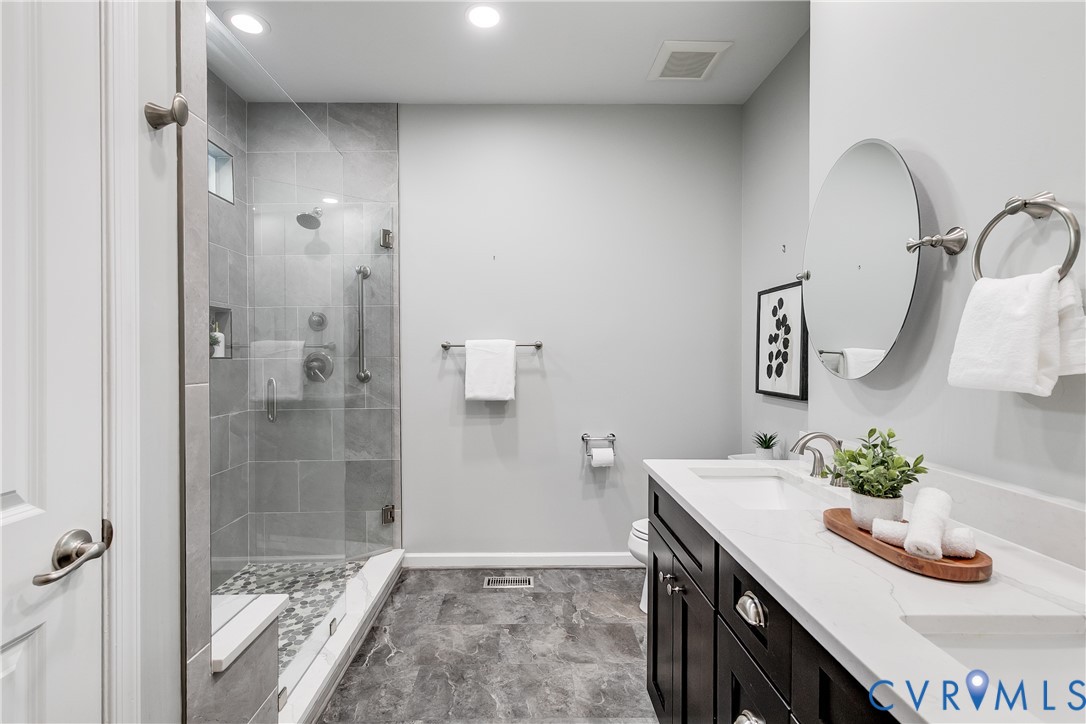 7538 South Franklins Way Quinton, VA 23141 - Photo 25 of 48 a bathroom with a granite countertop sink a mirror and shower