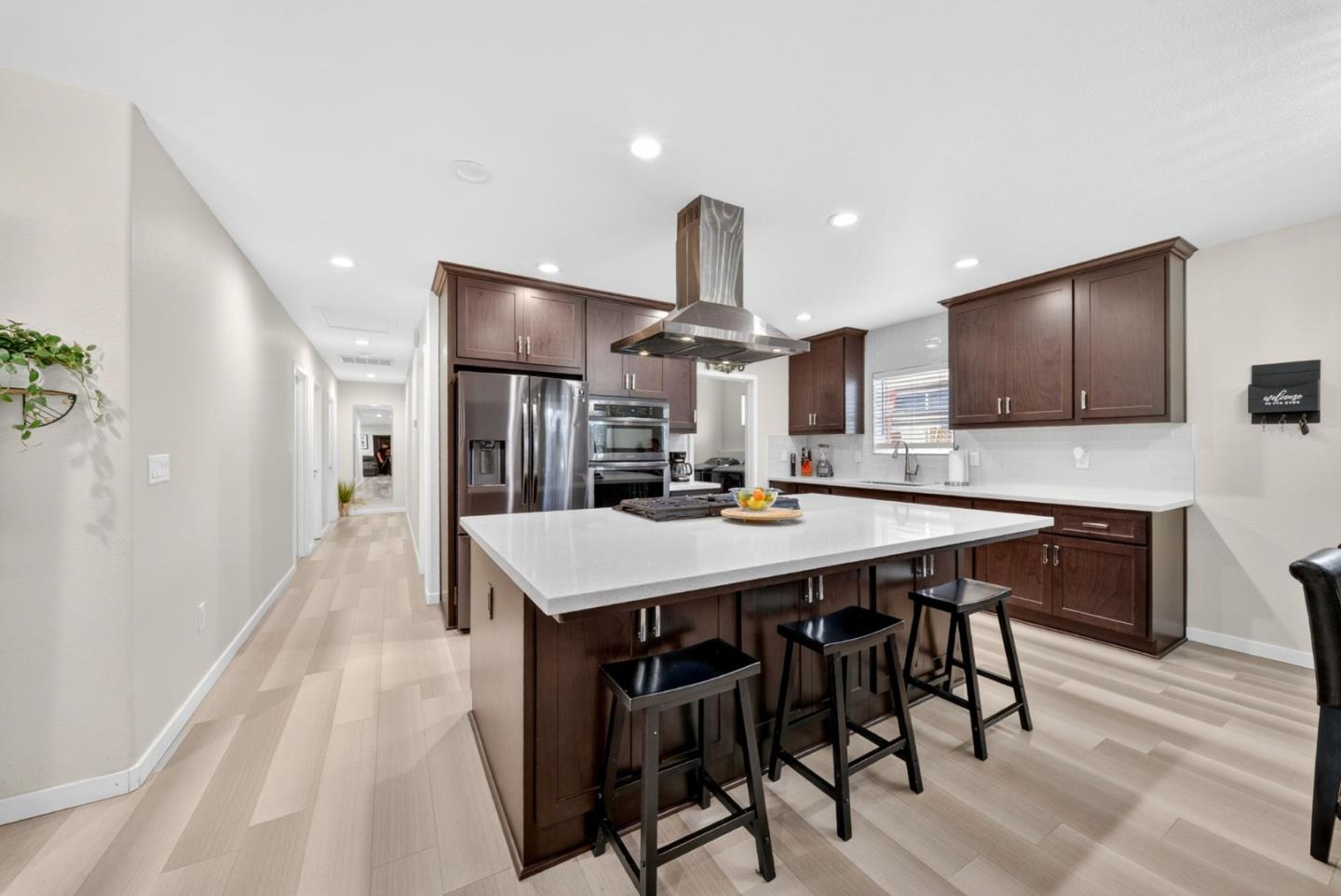 919 Old Canyon Road Fremont, CA 94536 - Photo 8 of 55 a kitchen with a table chairs refrigerator and microwave