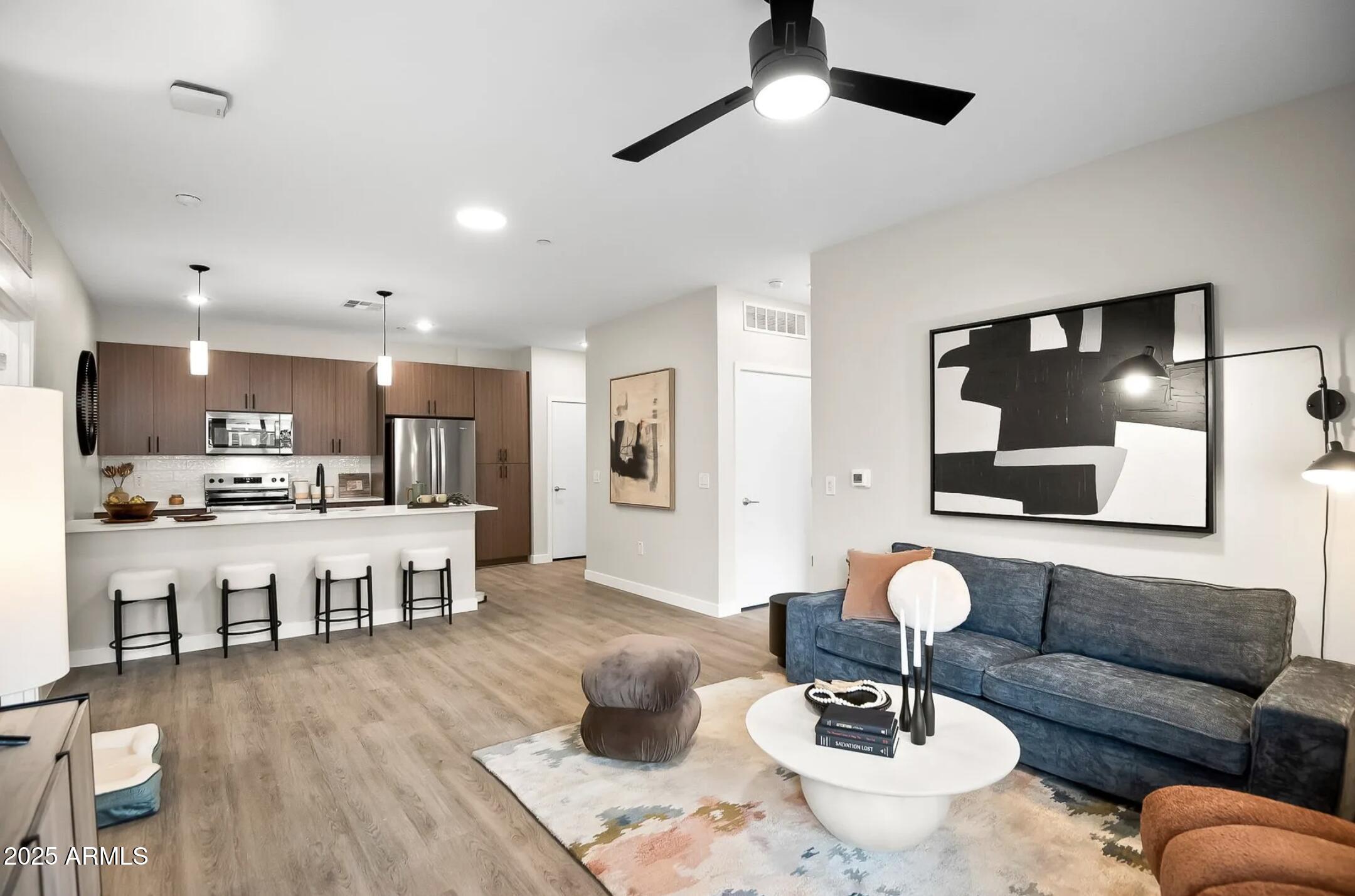 17445 West Lower Buckeye Road, Unit A1 Goodyear, AZ 85338 - Photo 25 of 35 Living Room/Kitchen